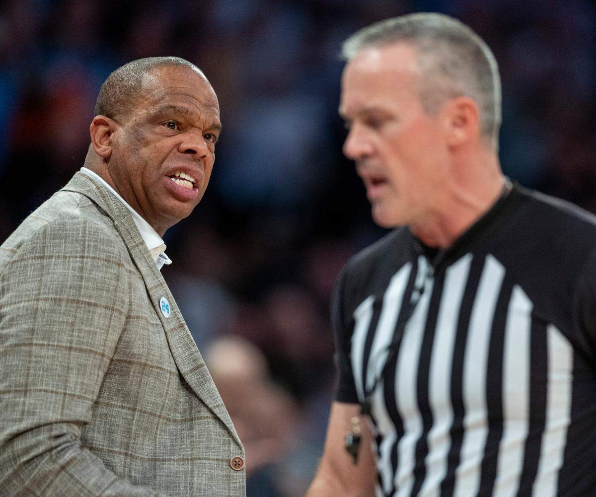 North Carolina coach Hubert Davis has a word with official Ron Groover following a technical foul on Armando Bacot (5) during the first half against Connecticut in the Jimmy V Classic on Tuesday, December 5, 2023 at Madison Square Garden in New York, NY.