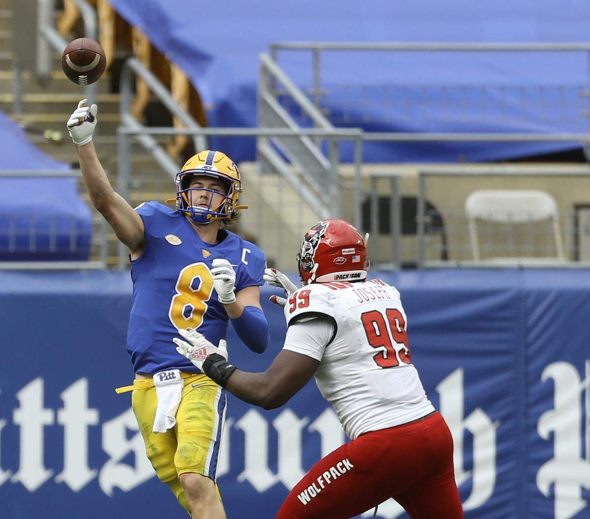 Pittsburgh Panthers quarterback Kenny Pickett (8) passes as N.C. State’s Daniel Joseph (99) pressures him during the Wolfpack’s game against the Panthers at Heinz Field in Pittsburgh, PA, Saturday, Oct. 3, 2020.