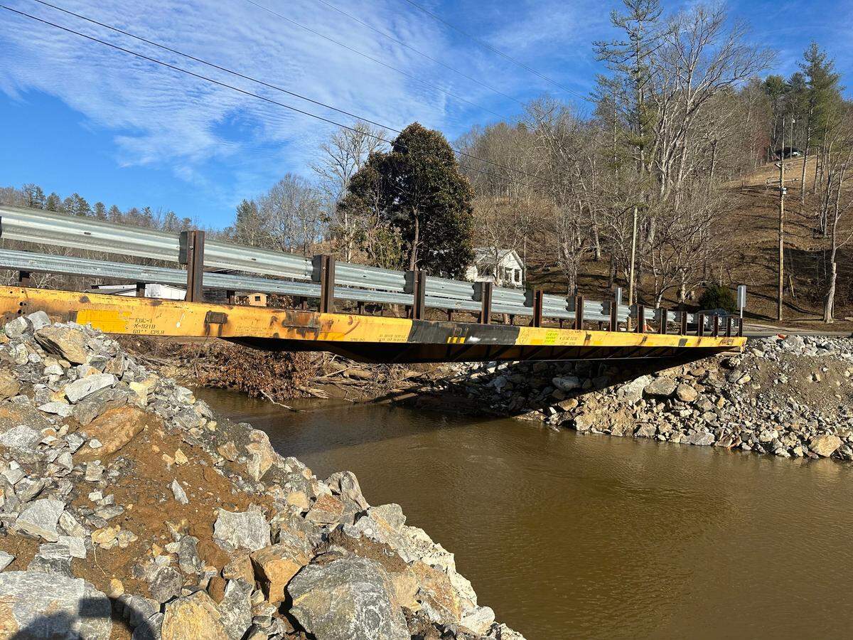 The old railroad car markings are visible on the side of the new Hobson Branch Road bridge over Ivy Creek in Buncombe County, North Carolina. The temporary bridge opened Feb. 7, 2025, replacing one that was washed out by the remnants of Hurricane Helene in September.