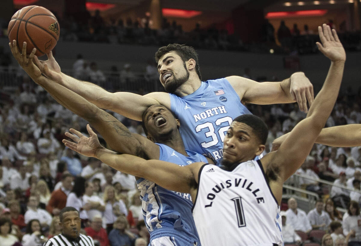 North Carolina’s Luke Maye (32) and Kenny Williams (24) go after an offensive rebound over Christen Cunningham (1) during the second half on Saturday, February 2, 2019 at the KFC Yum! Center in Louisville, Ky.