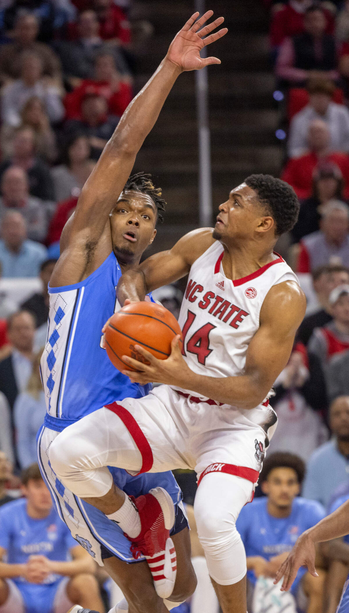 North Carolina’s Harrison Ingram (55) defends N.C. State’s Casey Morsell (14) in the first half on Wednesday, January 10, 2024 at PNC Arena in Raleigh, N.