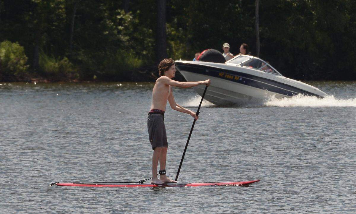 Bryce Tuton of Raleigh paddles across the calm waters of Falls Lake at the Highway 50 boat ramp in this July 2016 file photo.