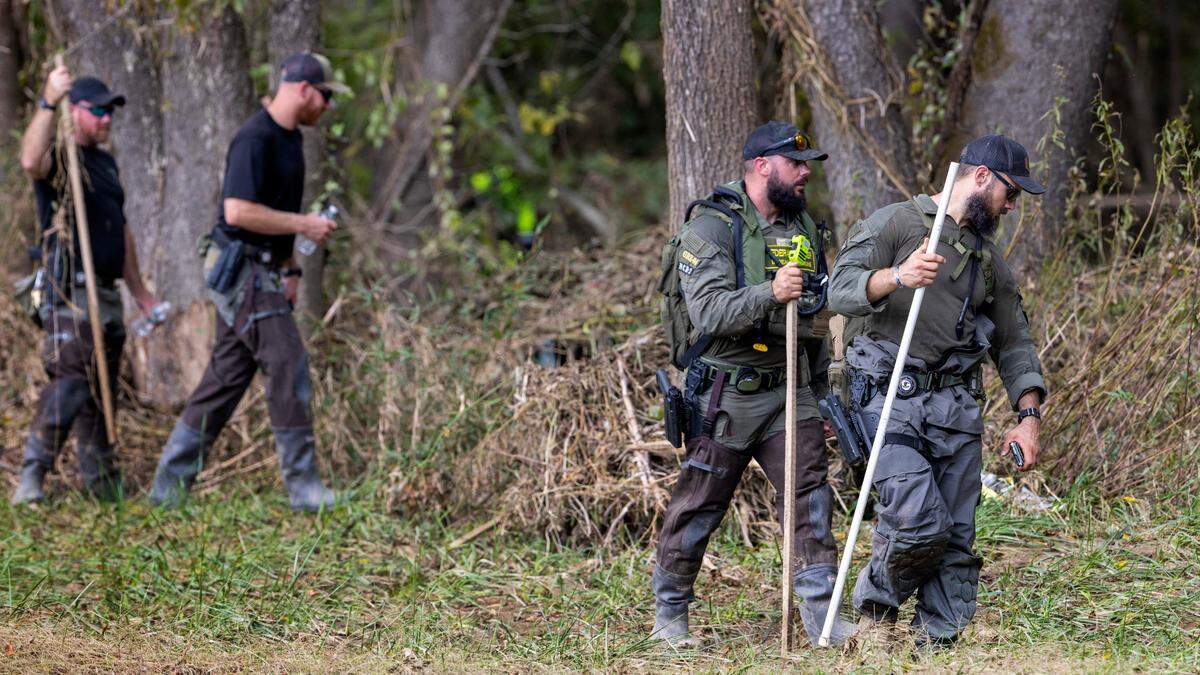 Search and rescue personnel from Colorado, Illinois and North Carolina search a stretch of farm land along the Catawba River for victims of Hurricane Helene on Wednesday, October 2, 2024 near Old Fort, N.C.