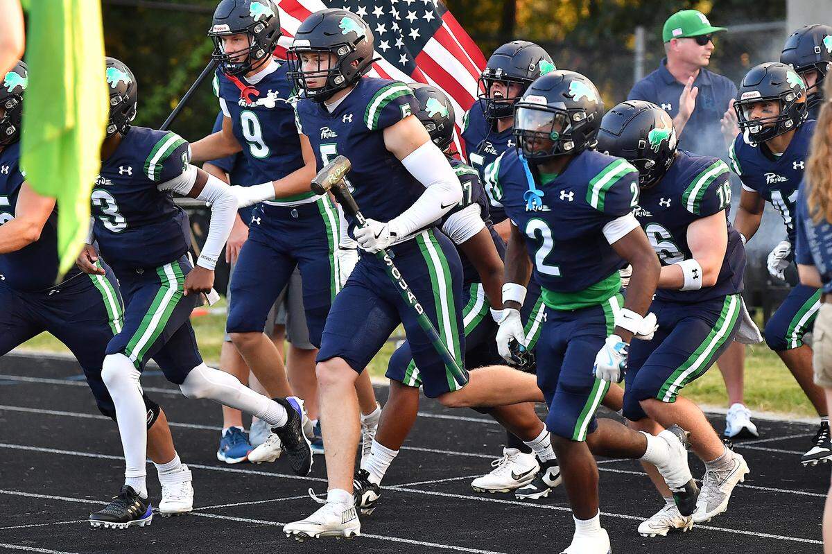 Leesville Road's Derek Schemenauer (5) rushes onto the field with teammates before their game with Heritage in Raleigh.  The Leesville Road Pride and the Heritage Huskies met in a  football game in Raleigh, N.C. on September 5, 2025.
