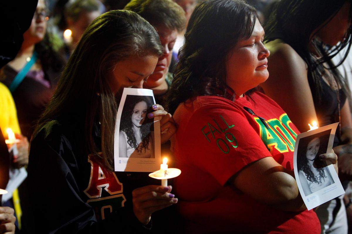 Briana Moore, left, and April Hammonds gather with hundreds to remember Haliwa-Saponi tribe member and UNC student, Faith Hedgepeth, during a vigil   in September 2012,at UNC Chapel Hill. 