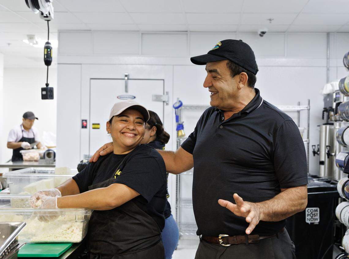 Mediterranean Deli owner Jamil Kadoura greets prep cook Eva Ordonez in the restaurant’s kitchen on Thursday, Sept. 4, 2025, in Chapel Hill, N.C. The restaurant will reopen on Tuesday following a July 2023 fire.