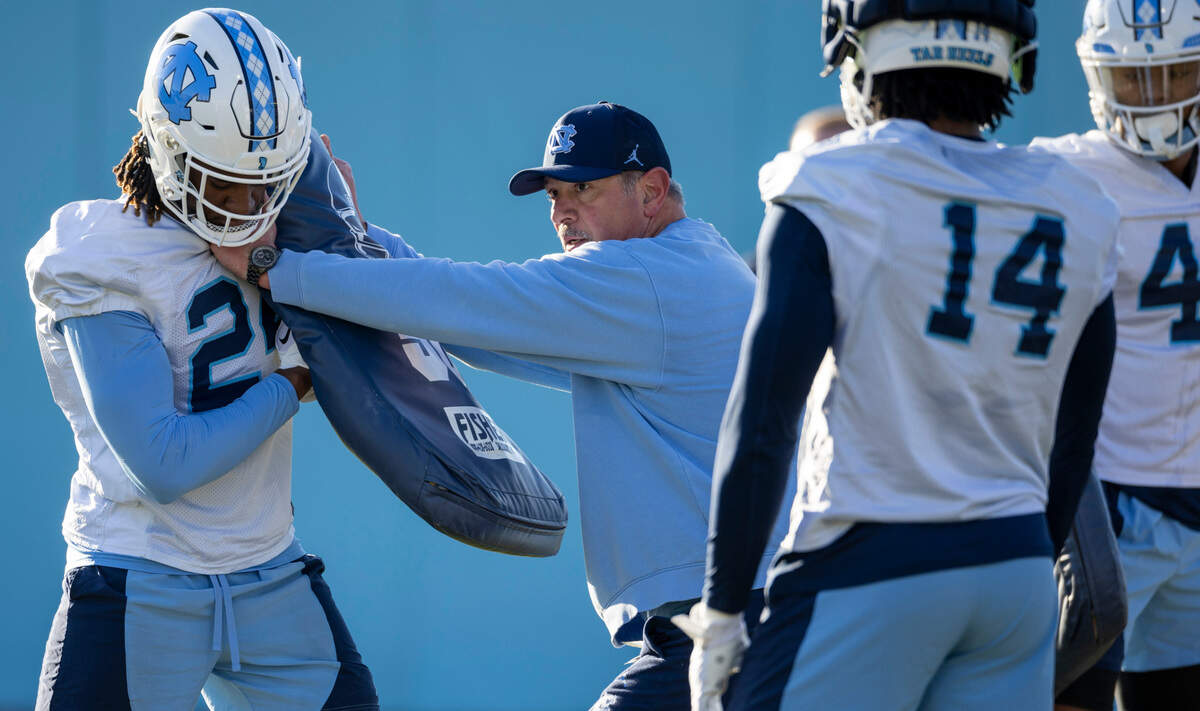Defensive line coach Ted Monachino works with jack, Mali Hamrick (24) during the opening day of their spring football practice on Tuesday, March 19, 2024 in Chapel Hill, N.C.