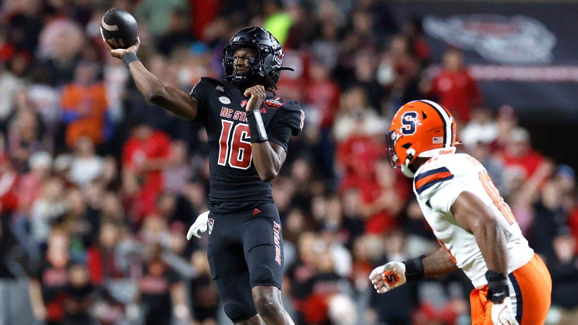 N.C. State quarterback CJ Bailey (16) passes while Syracuse defensive lineman Fadil Diggs (10) closes in during the first half of N.C. State’s game against Syracuse at Carter-Finley Stadium in Raleigh, N.C., Saturday, Oct. 12, 2024.