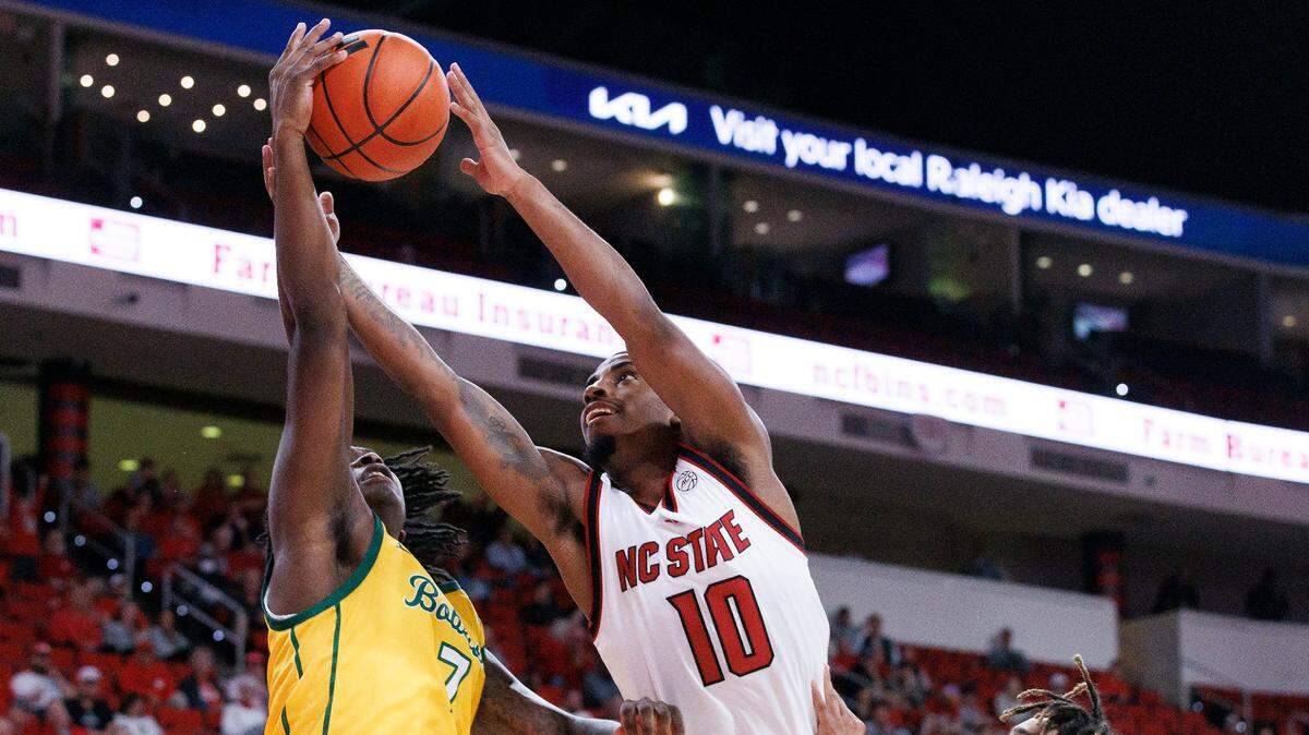 N.C. State’s Marcus Hill, Jr. is pressured by Lees-McRae’s Anthony Parker and Dre Jackson during the first half of the Wolfpack’s 79-75 exhibition win on Wednesday, Oct. 30, 2024, at the Lenovo Center.