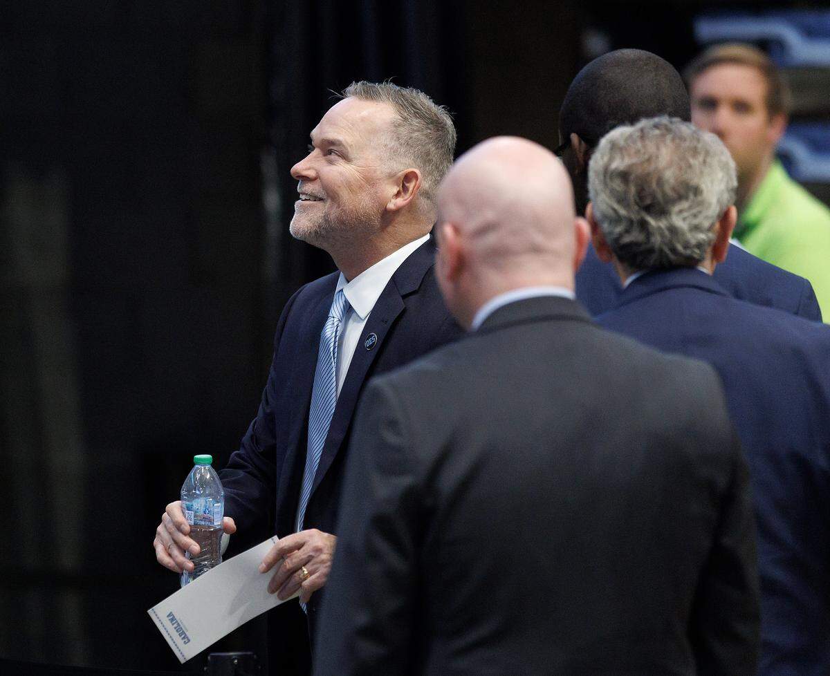 New North Carolina men’s basketball coach Michael Malone smiles up at fans following a press conference at the Smith Center on Tuesday, April 7, 2026, in Chapel Hill, N.C. 
