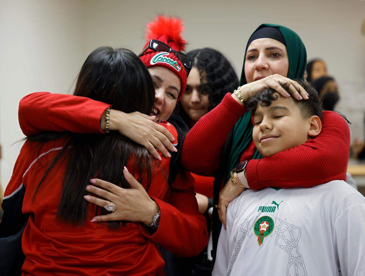 Fans embrace after watching France’s 2-0 World Cup semifinal victory over Morocco at La Recette patisserie in Durham, N.C. on Wednesday, Dec. 14, 2022.