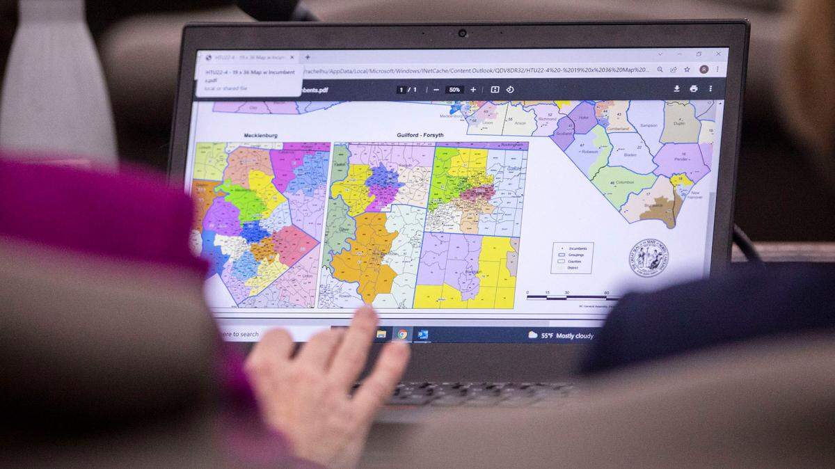 Congressional maps can be seen on the computer screen of Rep. Rachel Hunt before the start of a House committee meeting on redistricting at the Legislative Office Building in Raleigh, N.C. on Wednesday, Feb. 16, 2022.