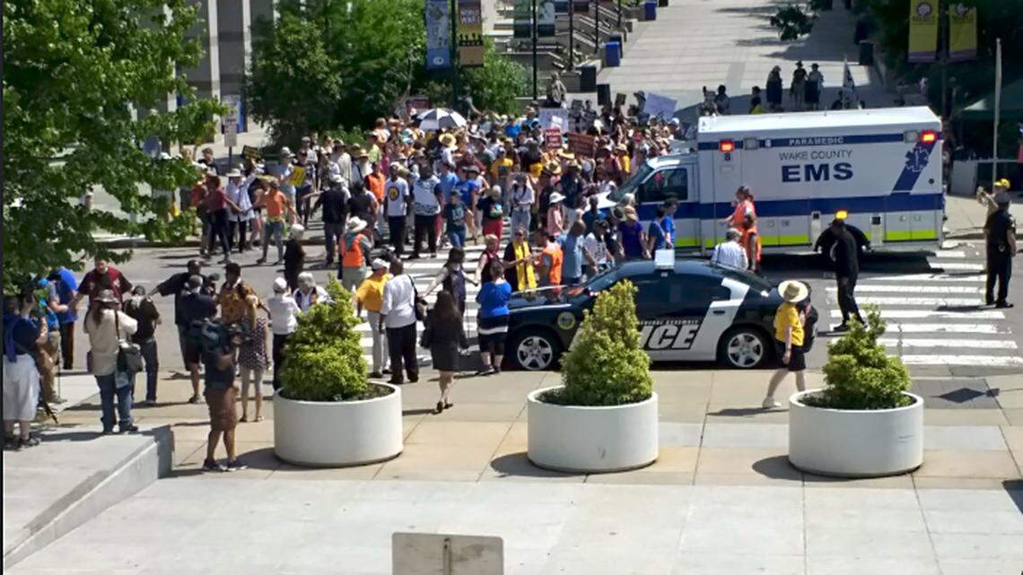 Protesters join hands to block Jones Street at the N.C. Legislature.