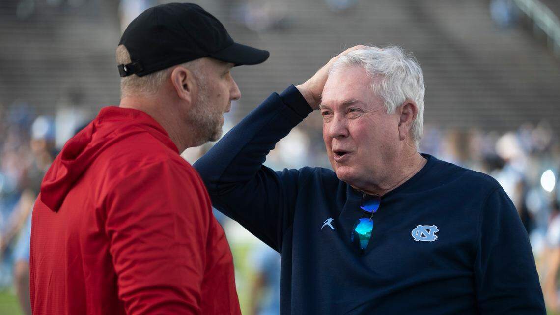 North Carolina coach Mack Brown, right, talks with N.C. State coach Dave Doeren prior to their game on Friday, Nov. 25, 2022, at Kenan Stadium in Chapel Hill, N.C.