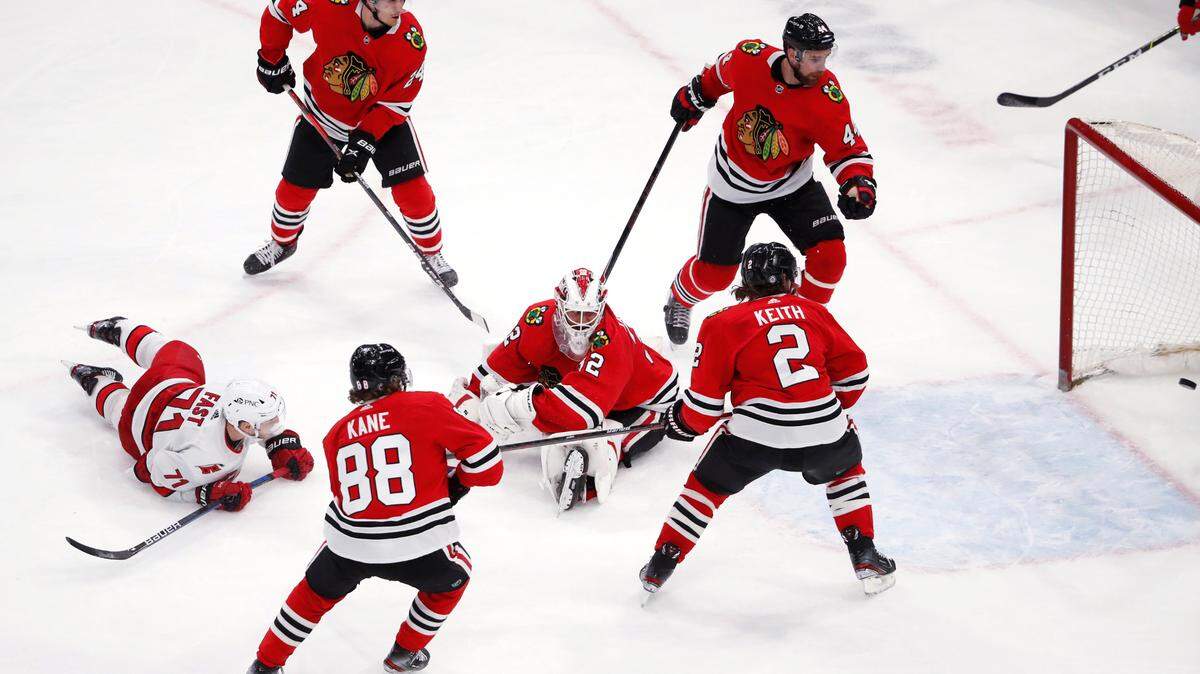 Carolina Hurricanes right wing Jesper Fast (71) watches his goal against Chicago Blackhawks goaltender Kevin Lankinen (32) during the third period of an NHL hockey game Thursday, April 1, 2021, in Chicago. The Hurricanes won 4-3. (AP Photo/Jeff Haynes)