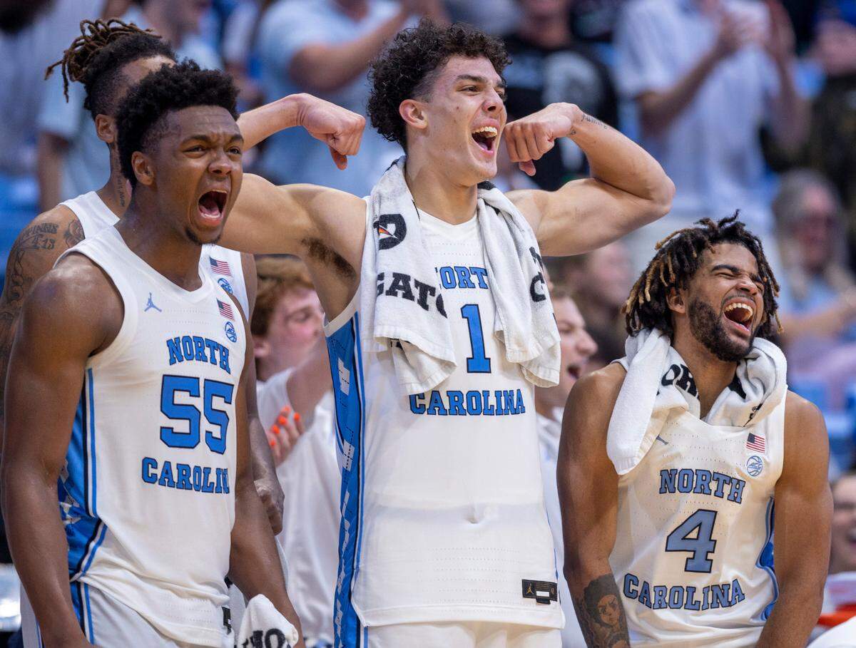 North Carolina’s Harrison Ingram (55), Zayden High (1) and R.J. Davis (4) celebrate after a basket by reserve player Duwe Farris (34) to give the Tar Heels’ a 113-53 lead against St. Augustine’s on Friday, October 27, 2023 at the Smith Center in Chapel Hill, N.C.