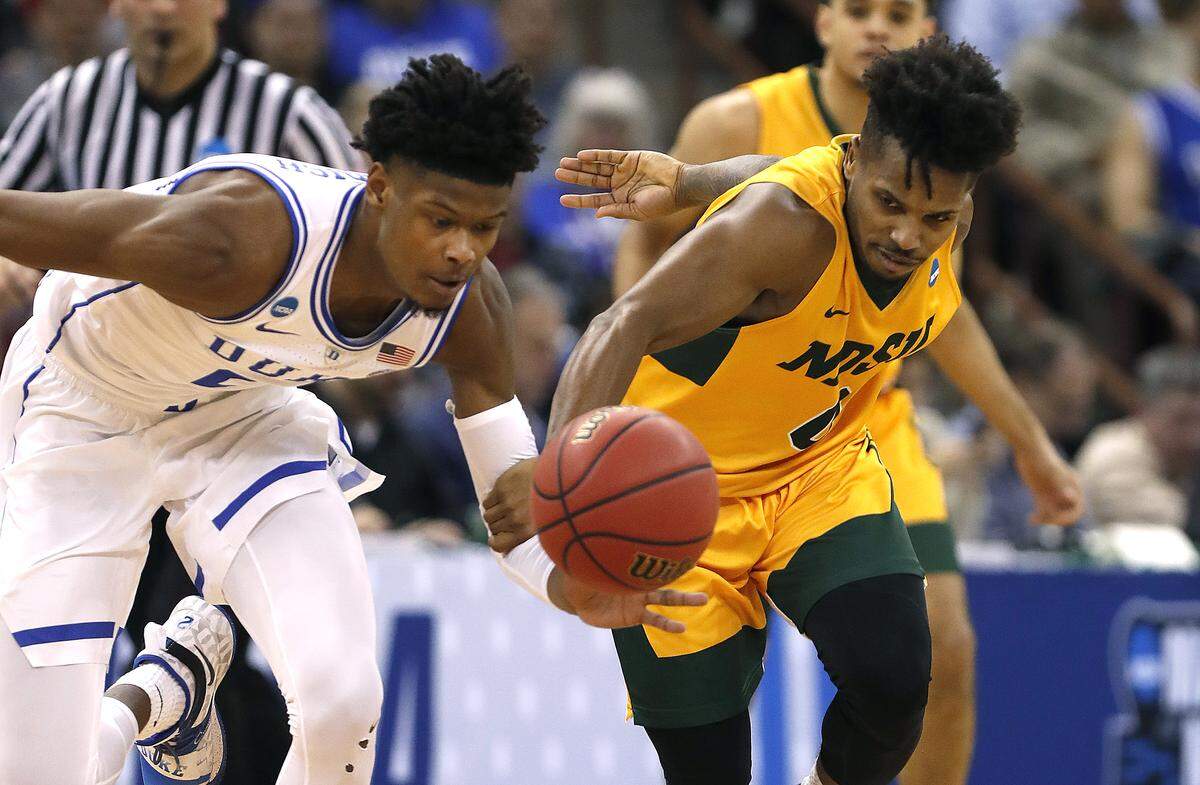 Duke’s Cam Reddish (2) steals the ball from North Dakota State’s Vinnie Shahid (0) during the first half of Duke’s game against North Dakota State in the first round of the NCAA Men’s Basketball Championship in Columbia, S.C., Friday, March 22, 2019.