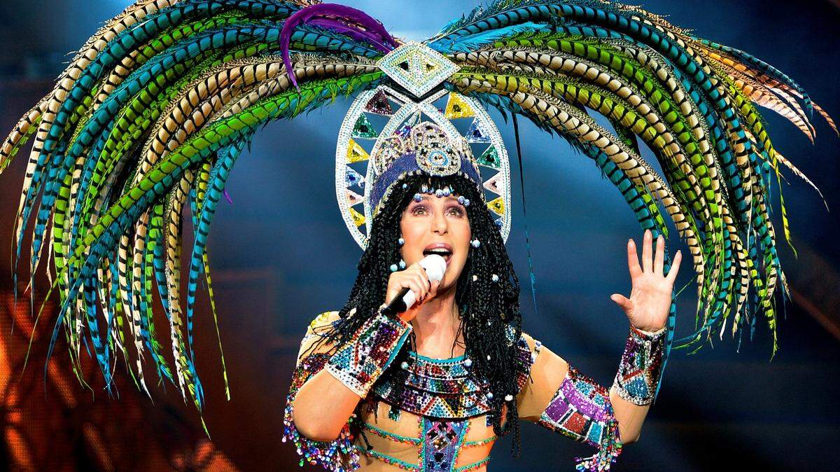 Cher, complete with an elaborate feather headress, opens her “Dressed to Kill Tour” concert with the song “Woman’s World” Wednesday night, May 7, 2014 concert at PNC Arena in Raleigh, NC.