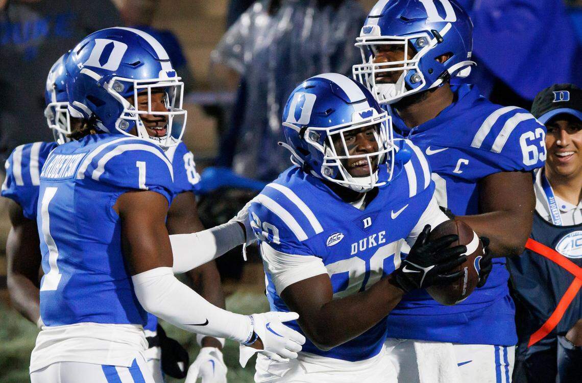 Duke’s Jaquez Moore (20) celebrates with Jontavis Robertson (1) and Jacob Monk (63) after scoring a touchdown against Virginia during the second half of an NCAA college football game in Durham, N.C., Saturday, Oct. 1, 2022.