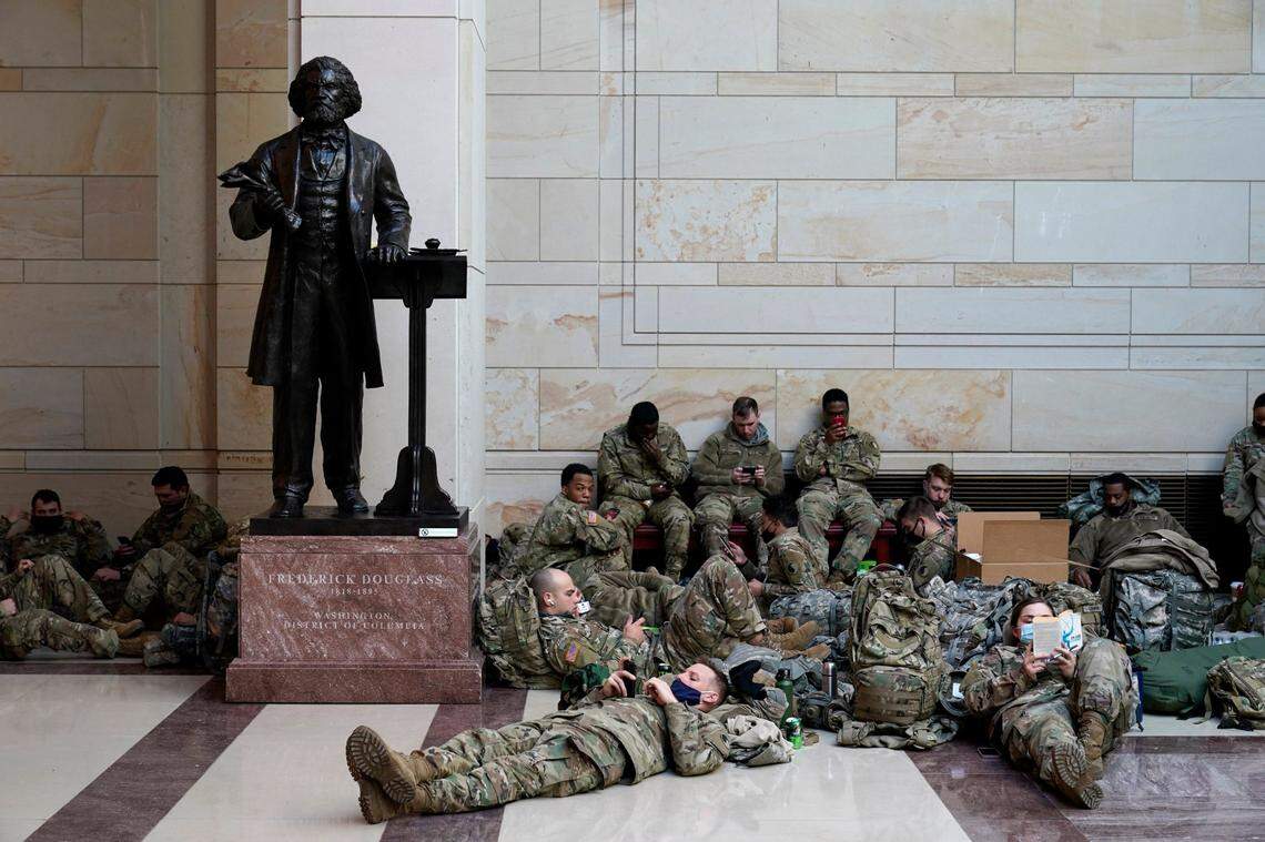 Troops hold inside the Capitol Visitor’s Center to reinforce security at the Capitol in Washington, Wednesday, Jan. 13, 2021. The House of Representatives is pursuing an article of impeachment against President Donald Trump for his role in inciting an angry mob to storm the Capitol last week.