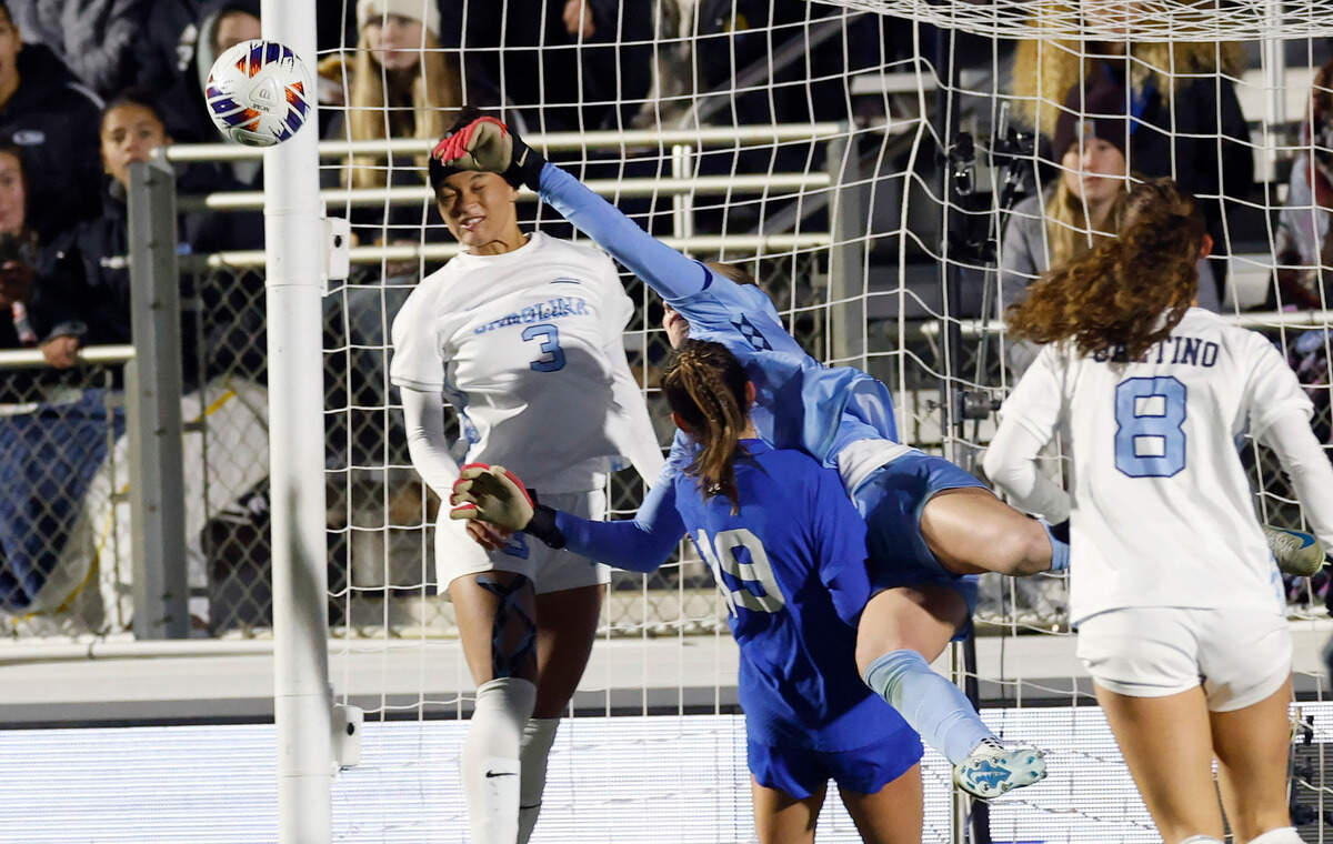North Carolina’s Clare Gagne (0) knocks the ball away as Duke’s Maggie Graham (19) challenges her during the first half of UNC’s game against Duke in the semifinals of the 2024 Women’s College Cup at WakeMed Soccer Park in Cary, N.C., Friday, Dec. 6, 2024. North Carolina’s Trinity Armstrong (3) also defends.