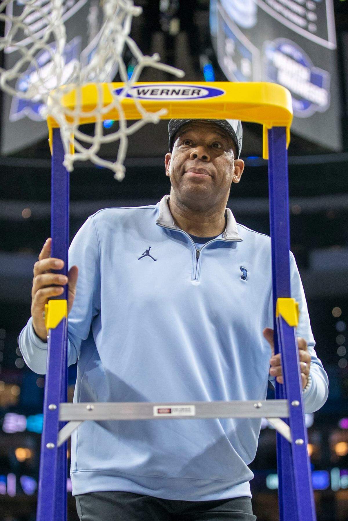 North Carolina coach Hubert Davis climbs the ladder to cut down the net following the Tar Heels 69-49 victory over Saint Peters in the NCAA East Regional Championship game on Sunday, March 27, 2022 at Wells Fargo Center in Philadelphia, Pa.