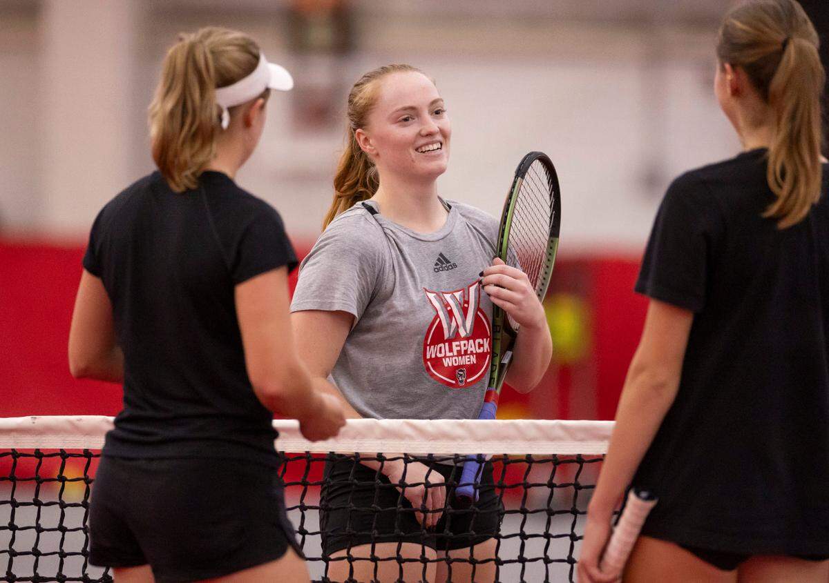 N.C. State senior Sophie Abrams talks with her teammates during practice at the J.W. Isenhour Tennis Center on Thursday, January 25, 2024 in Raleigh, NC.