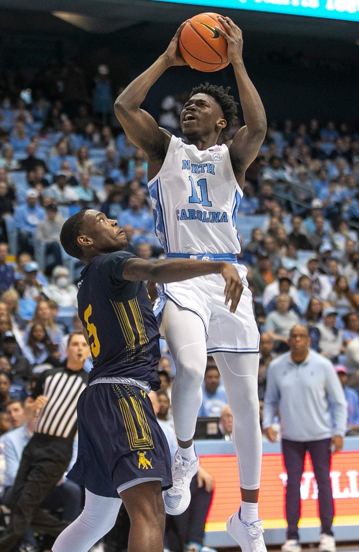 North Carolina’s D’Marco Dunn (11) drives to the basket against Johnson C. Smith’s Ezekiel Cannedy (5) in the second half during an exhibition game on Friday, October 28, 2022 at the Smith Center in Chapel Hill, N.C.