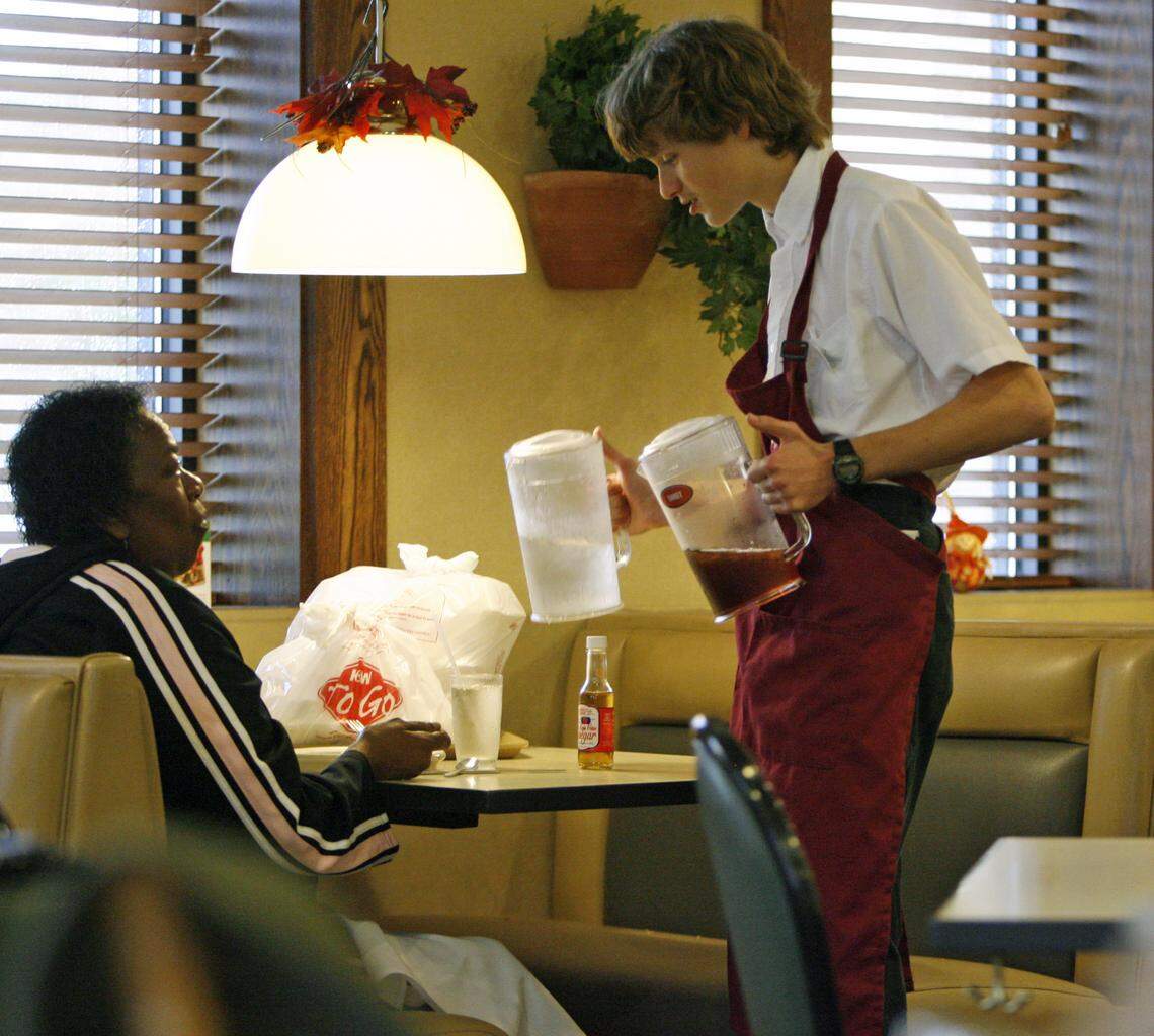 A server offers to refill a customer's drink during a lunch shift at K&W Cafeteria in this undated photo.