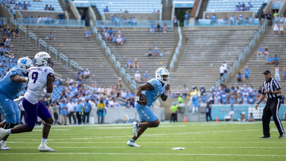 Down 63-38 to James Madison, with the west end of Kenan Stadium noticeably empty, North Carolina quarterback Jacolby Criswell (12) rushes for seven yards in the fourth quarter on Saturday, September 21, 2024 at Kenan Stadium in Chapel Hill, N.C.