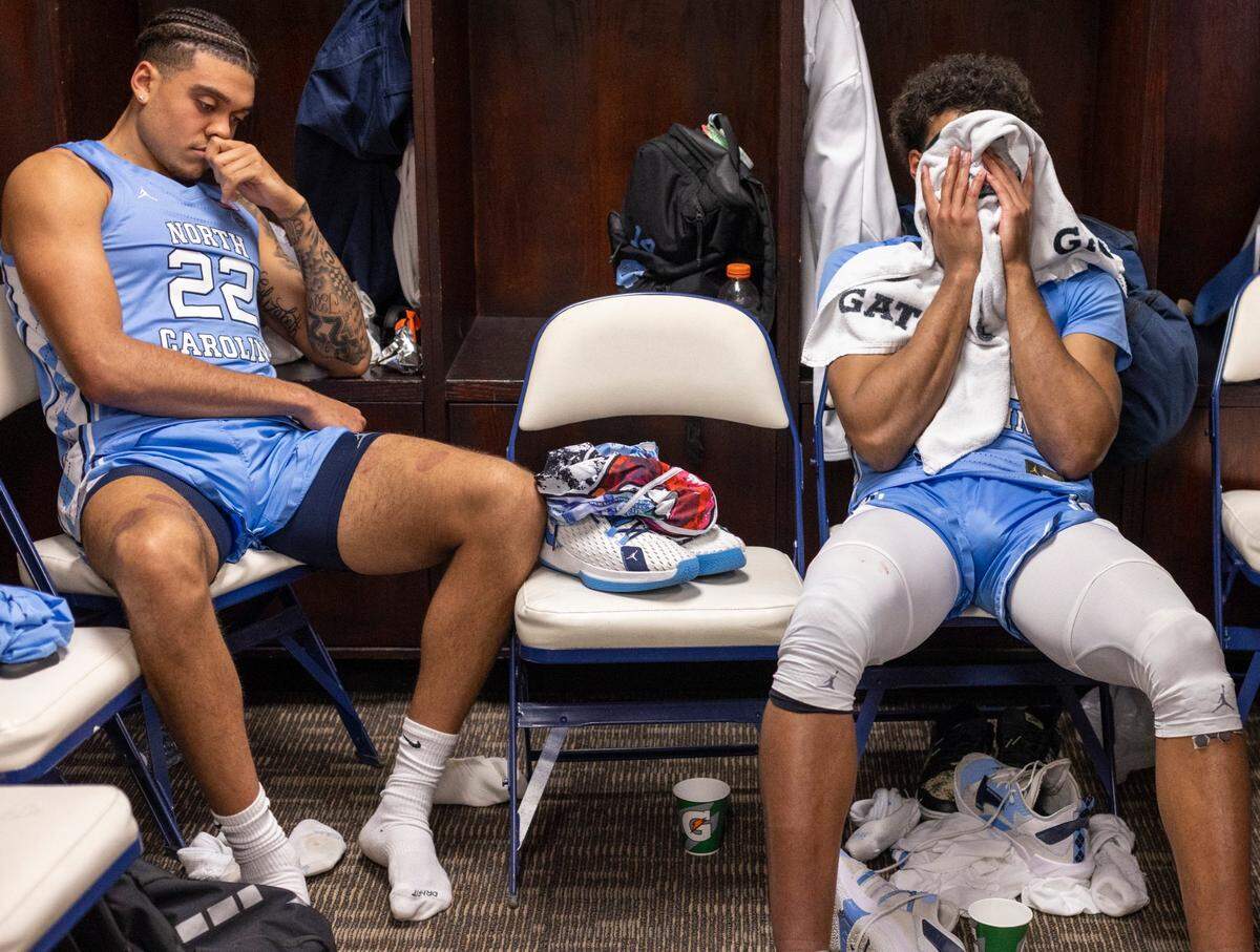 North Carolina’s Justin McKoy (22) and Puff Johnson (14) sit dejected in their lockers following the Tar Heels’ 68-59 loss to Virginia the third round of the ACC Tournament on Thursday, March 9, 2023 at the Greensboro Coliseum in Greensboro, N.C.