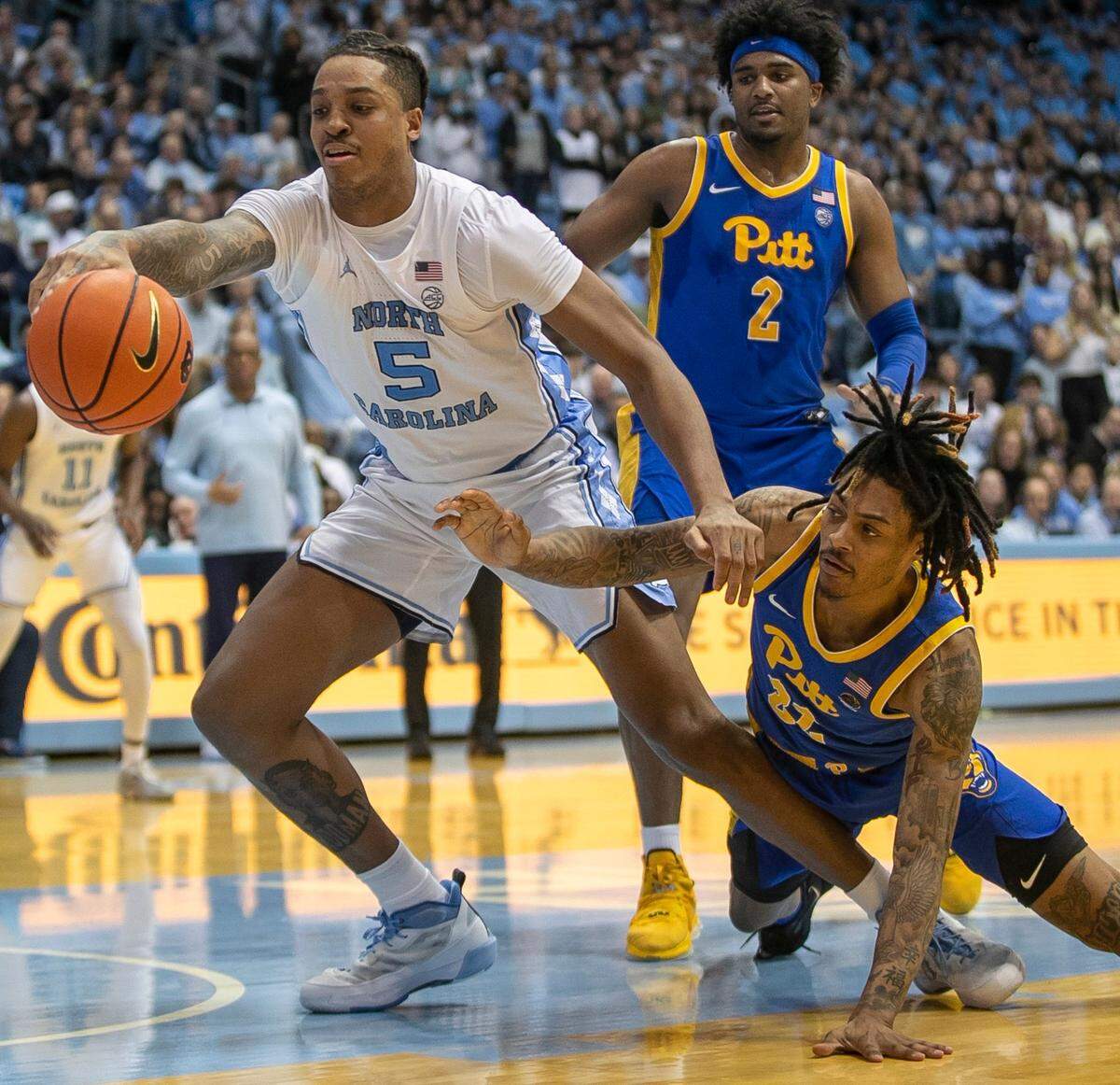 North Carolina’s Armando Bacot (5) and Pittsburgh’s Nike Sibande (22) battle for a loose ball during the second half on Wednesday, February 1, 2023 at the Smith Center in Chapel Hill, N.C.