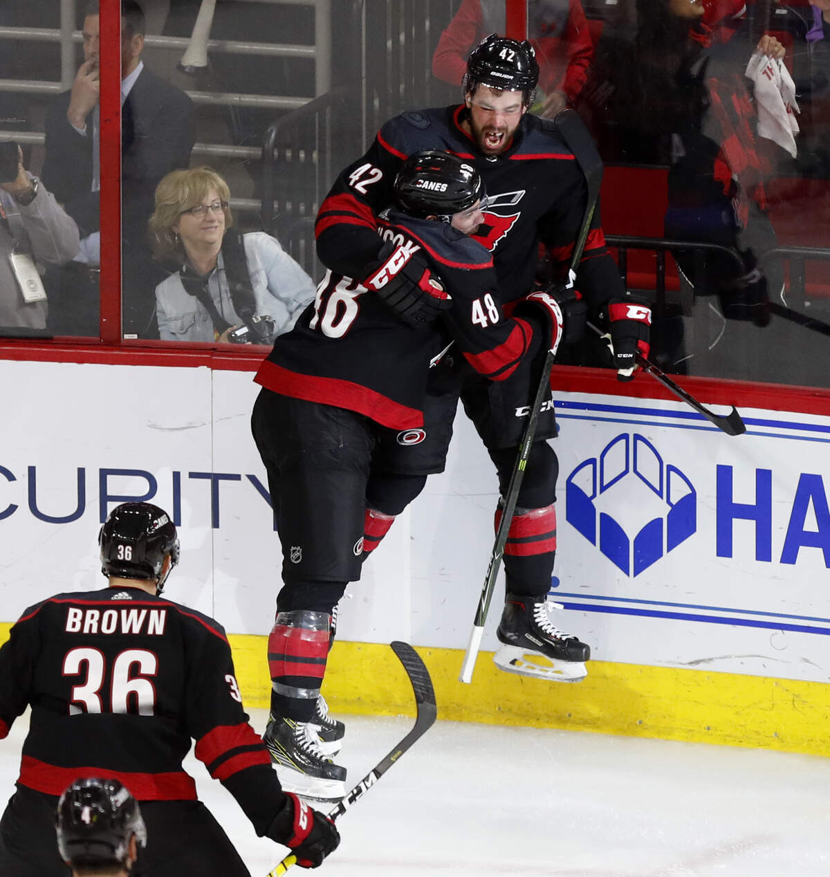 Carolina’s Greg McKegg (42) celebrates withJordan Martinook (48) and Patrick Brown (36) after scoring during the second period of the Carolina Hurricanes’ game against the New York Islanders at PNC Arena in Raleigh Friday, May 3, 2019.