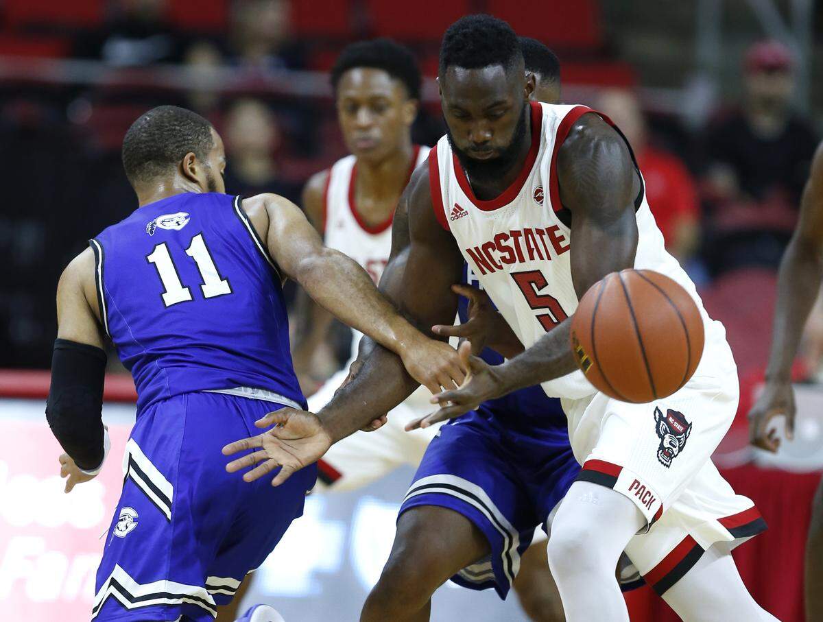 N.C. State’s Eric Lockett (5) steals the ball from Chowan’s Gus Rowland (11) during the first half of N.C. State’s exhibition game against Chowan at PNC Arena in Raleigh, N.C., Monday, Oct. 29, 2018.