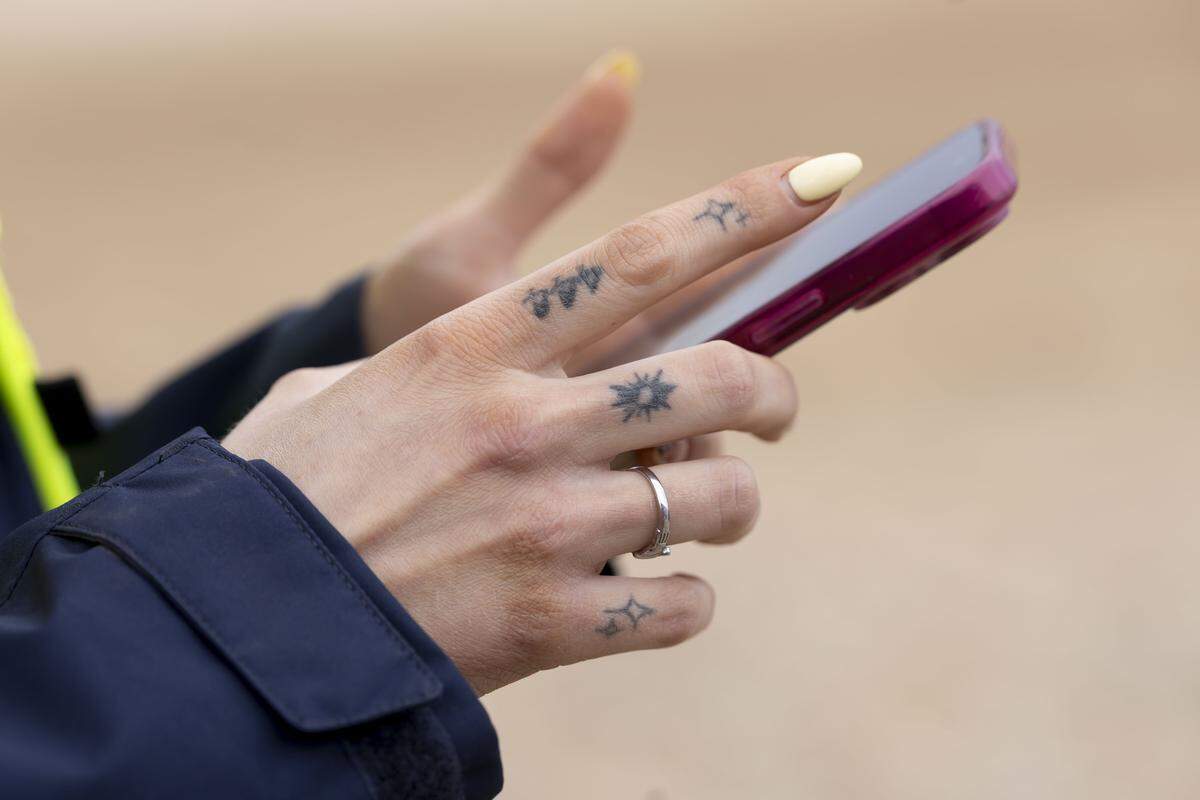 Project manager Sam Roth checks her messages at the Veridea mixed use development site. 