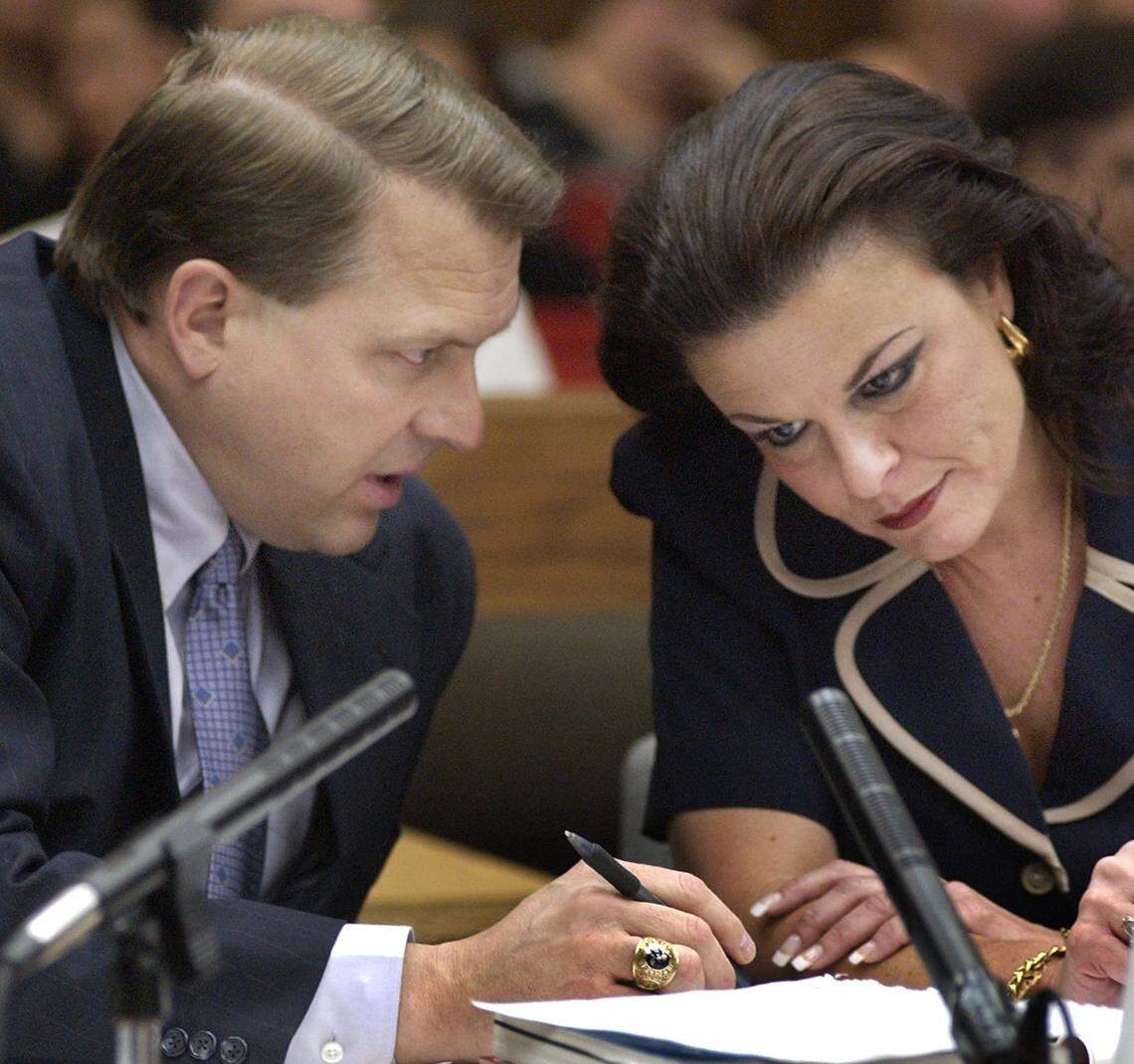 Durham District Attorney Jim Hardin (at left) confers with his Assistant DA Freda Black as the defense cross examines a prosecution witness Wednesday July 9, 2003 during the Michael Peterson murder trial.