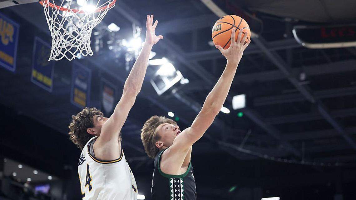 HENDERSON, NEVADA - MARCH 14: Gytis Nemeiksa #5 of the Hawaii Rainbow Warriors shoots against Kyle Evans #14 of the UC Irvine Anteaters during the first half of the Big West Conference tournament championship game at Lee's Family Forum on March 14, 2026 in Henderson, Nevada. (Photo by Ian Maule/Getty Images)