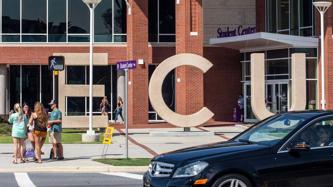 Students wait to cross 10th Street Tuesday, August 18, 2020 outside the Student Center at East Carolina University.