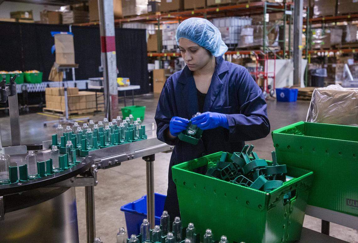 Jannelly Carcamo prepares bottles at the Murphy’s Naturals warehouse that would normally contain their normal best-selling product of insect repellent but now contain a hand sanitizer they have pivoted to produce during the coronavirus pandemic, on Friday, Apr. 10, 2020, in Raleigh, N.C. Some will be donated and some will be available to purchase on their website.