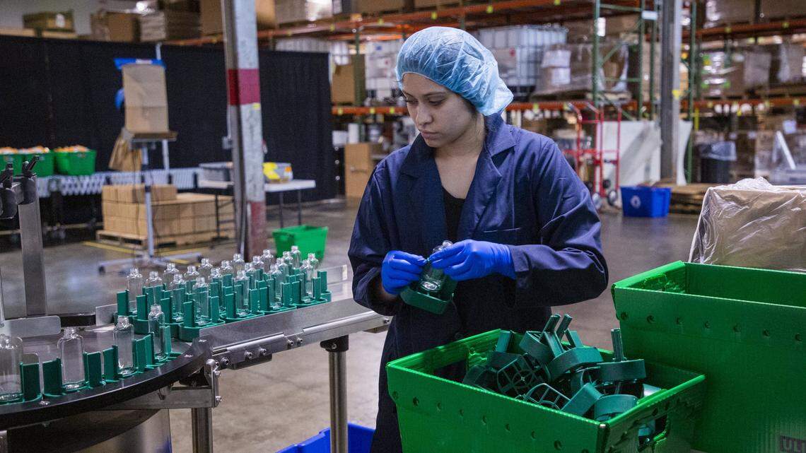 Jannelly Carcamo prepares bottles at the Murphy’s Naturals warehouse that would normally contain their normal best-selling product of insect repellent but now contain a hand sanitizer they have pivoted to produce during the coronavirus pandemic, on Friday, Apr. 10, 2020, in Raleigh, N.C. Some will be donated and some will be available to purchase on their website.