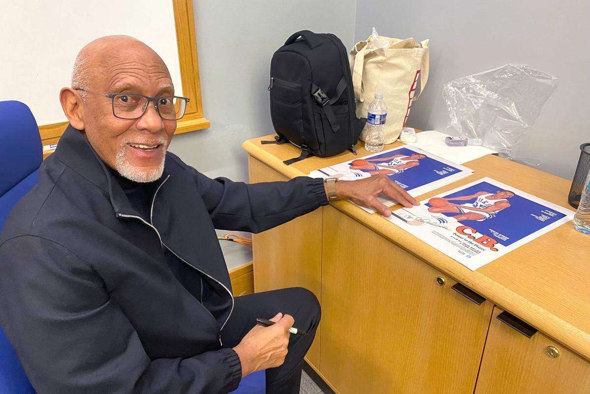 C.B. Claiborne signs movie posters following the pre-release screening of “CB: Power to the Player,” a short documentary about his journey to become Duke’s first Black basketball player. The documentary premiered to a small audience of invited guests on Wednesday Feb. 12, 2025, at the Krzyzewski Center, adjacent to Cameron Indoor Stadium.