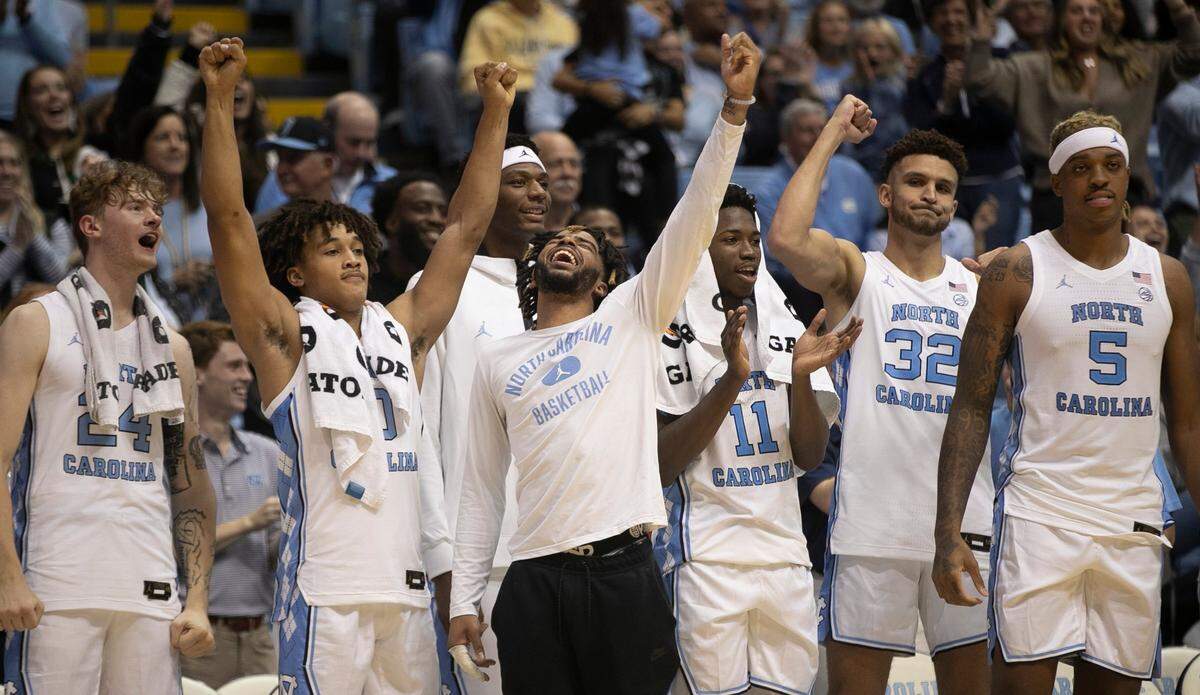 North Carolina’s R.J. Davis, center, reacts with his teammates after a free-throw by reserve player Rob Landry (15) to give the Tar Heels’ a 101-40 lead with 21 second to play against Johnson C. Smith on Friday, October 28, 2022 at the Smith Center in Chapel Hill, N.C.