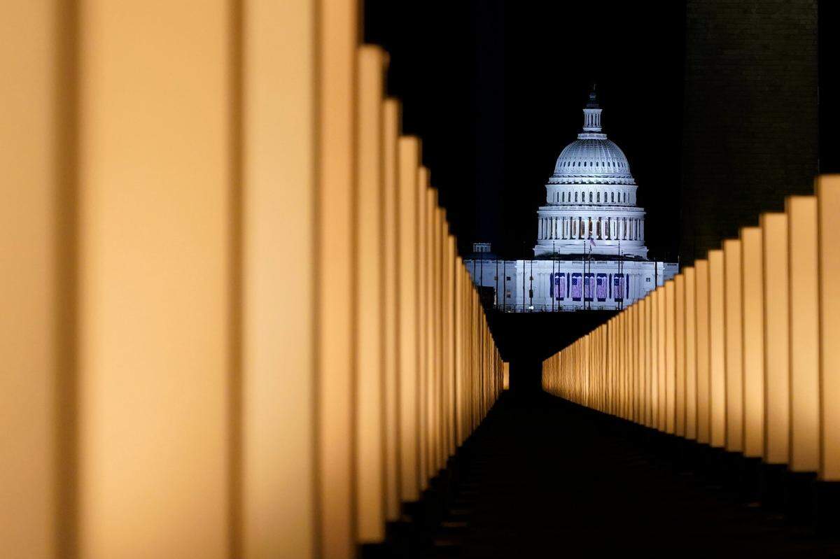 Lights surround the Lincoln Memorial Reflecting Pool, placed as a memorial to COVID-19 victims Tuesday, Jan. 19, 2021, in Washington, after President-elect Joe Biden spoke, with the U.S. Capitol in the background.
