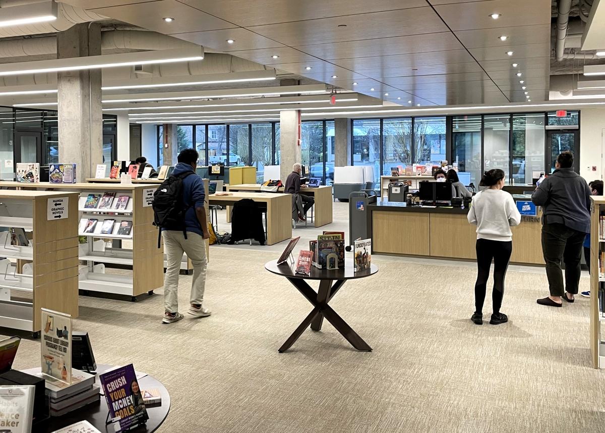 Patrons at the Southern Branch Library in Carrboro wait to check out their books on Wednesday, Feb. 12, 2025. The new library is located on the ground floor of the Drakeford Library Complex at 203 S. Greensboro St.