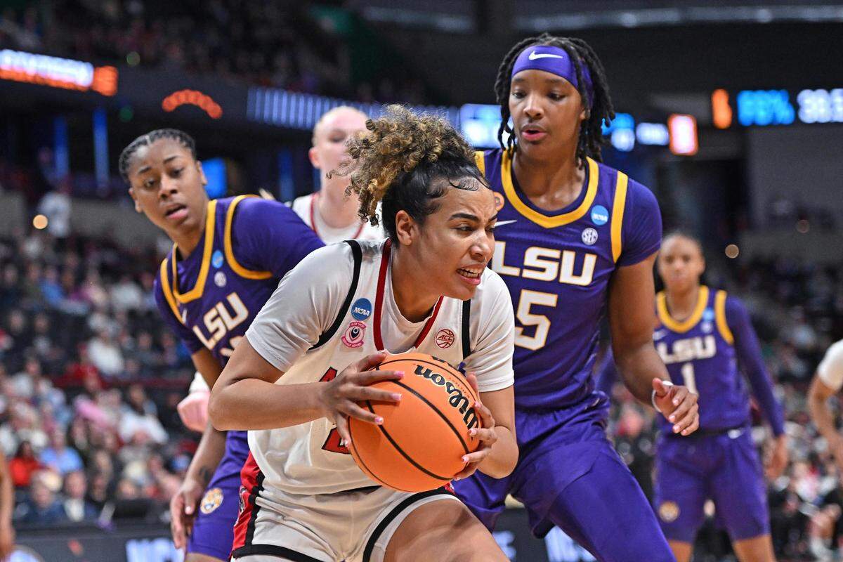 Mar 28, 2025; Spokane, WA, USA; NC State Wolfpack guard Madison Hayes (21) rebounds the ball against LSU Lady Tigers forward Sa’Myah Smith (5) during the first half of a Sweet 16 NCAA Tournament basketball game at Spokane Arena.