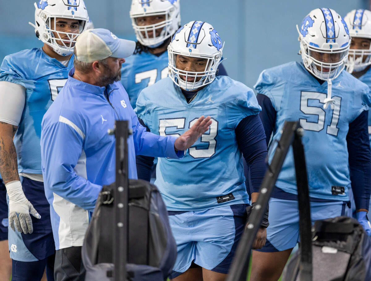 North Carolina offensive lineman Willie Lampkin (53) listens to coach Randy Clements during the opening day of spring football practice on Tuesday, March 19, 2024 in Chapel Hill, N.C.