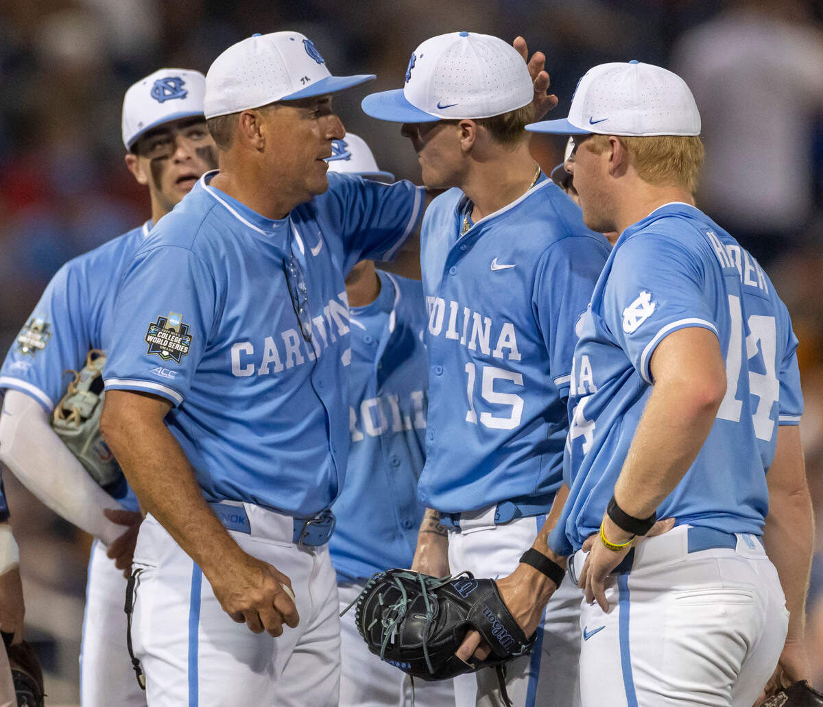 North Carolina coach Scott Forbes embraces pitcher Cameron Padgett (15) before removing him from the mound in the eighth inning against Tennessee in game six of the College World Series on Sunday, June 16, 2024 at Charles Swab Field in Omaha, Nebraska.