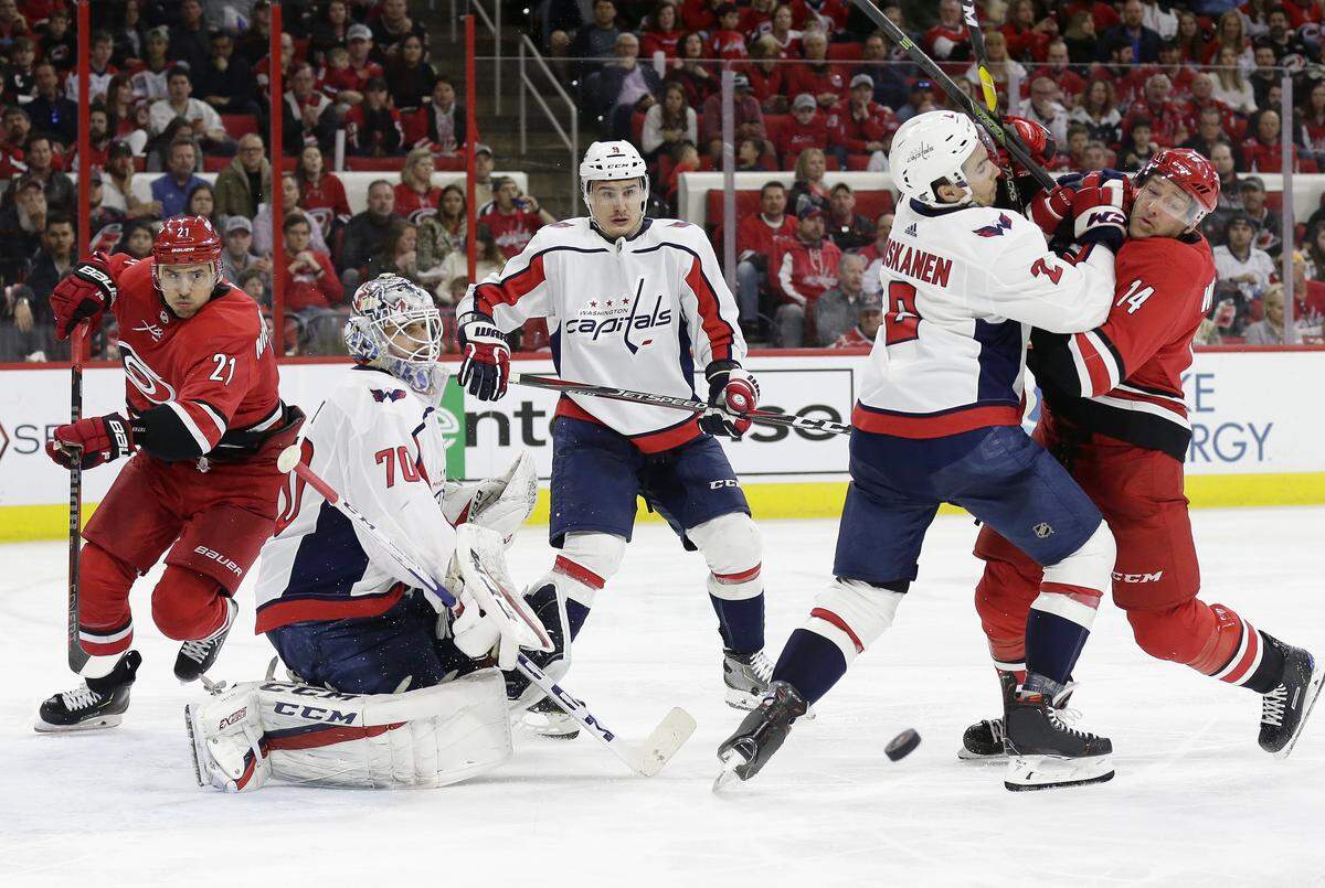 FILE - In this March 28, 2019, file photo, Carolina Hurricanes’ Justin Williams (14) and Washington Capitals’ Matt Niskanen (2) struggle in front of Capitals’ Dmitry Orlov (9), of Russia, and goalie Braden Holtby (70) while Hurricanes’ Nino Niederreiter (21), of the Czech Republic, skates during the third period of an NHL hockey game, in Raleigh, N.C. The Hurricanes and Capitals begin a first round playoff series on Thursday, April 11. (AP Photo/Gerry Broome, File)