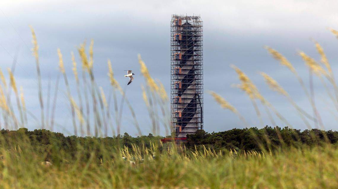 The Cape Hatteras Lighthouse is surrounded by scaffolding as it undergoes restoration on Monday, July 1, 2024. The project is expected to cost $19.2 million and will include replacing 40,000 of its estimated 1,250,000 bricks, replacing rusted or broken metal components and the installation of a near-exact replica of the first-order Fresnel lens.