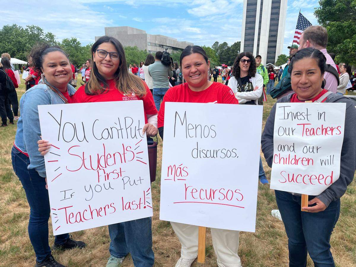 Staff from Carrboro Elementary — from left, Zaile Letriz, Emily Menjivar, Mayra Menjivar and Lizbet Garcia — rally at the NCAE protest Friday. Mayra Menjivar said she and others want to use their voice to speak up for children and those in their community who cannot.